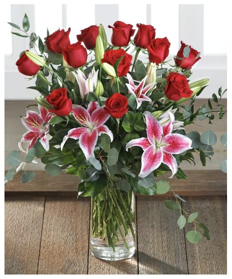 18 long stem roses accented with lilies