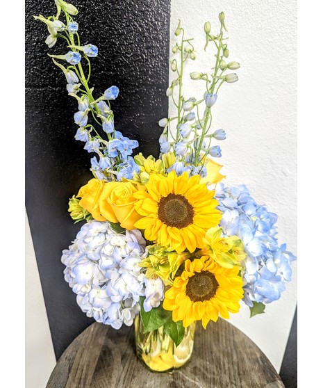 sunflowers, roses, and hydrangeas in floral arrangement